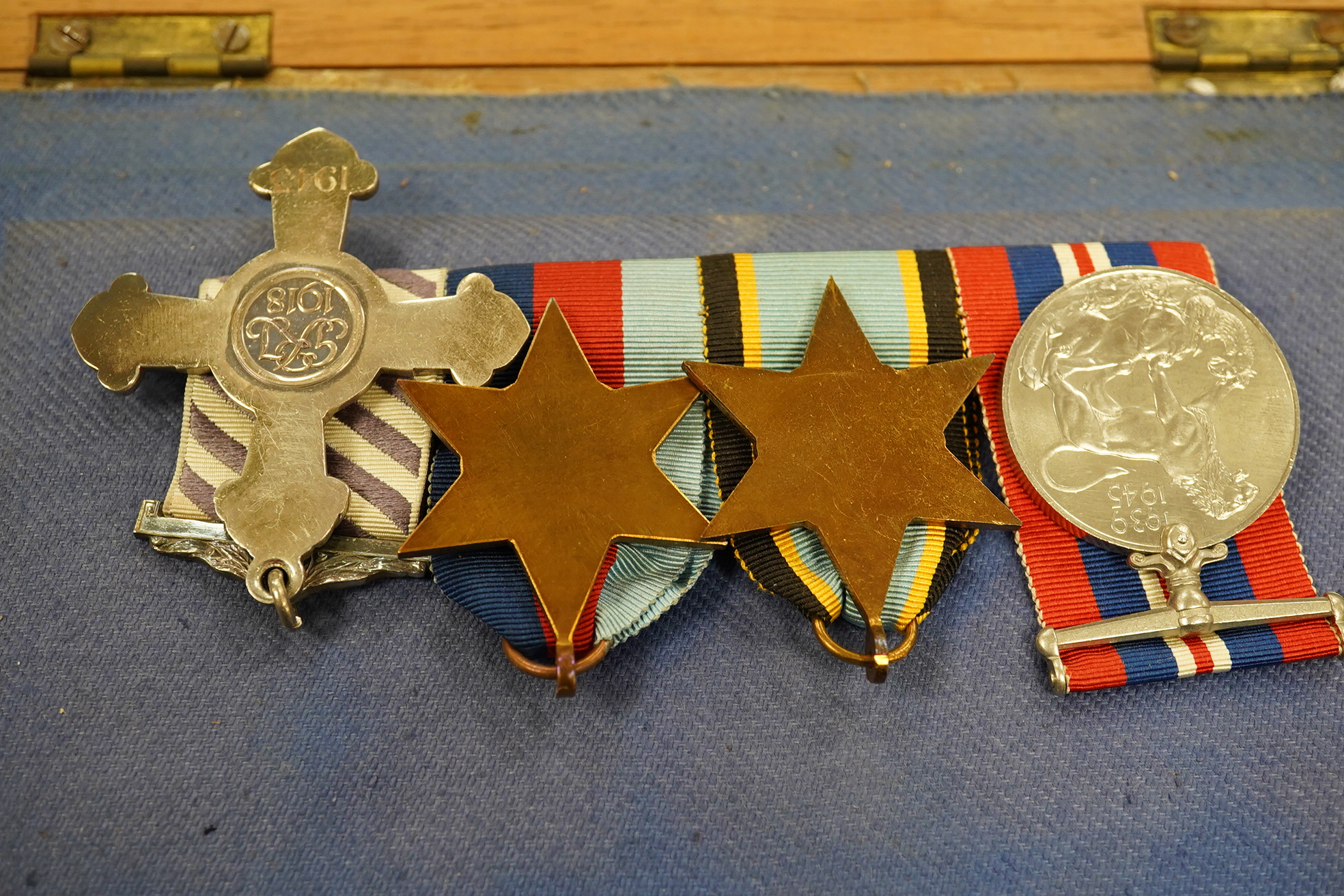 A DFC medal group with an Air Crew Europe star in a display case. Condition - good